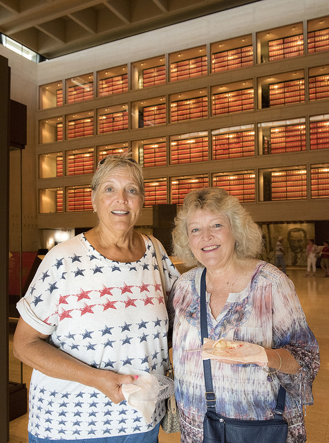 Two ladies eat cake in the LBJ Library great hall